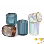 Ribbed glass candle jars in blue, brown and iridescent custom finishes